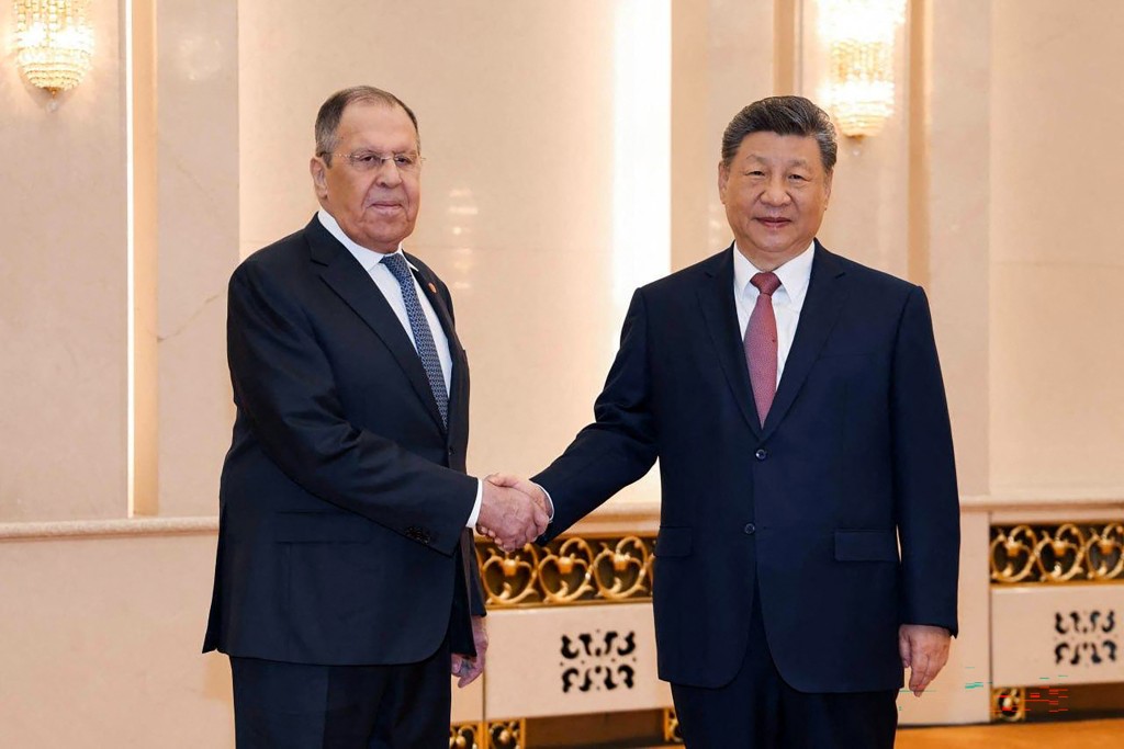 Photo by HANDOUT / RUSSIAN FOREIGN MINISTRY / AFP  This handout picture posted on the Telegram account of the Russian Foreign Ministry on April 15, 2026 shows Russia's Foreign Minister Sergei Lavrov (L) shaking hands with China's President Xi Jinping in Beijing.