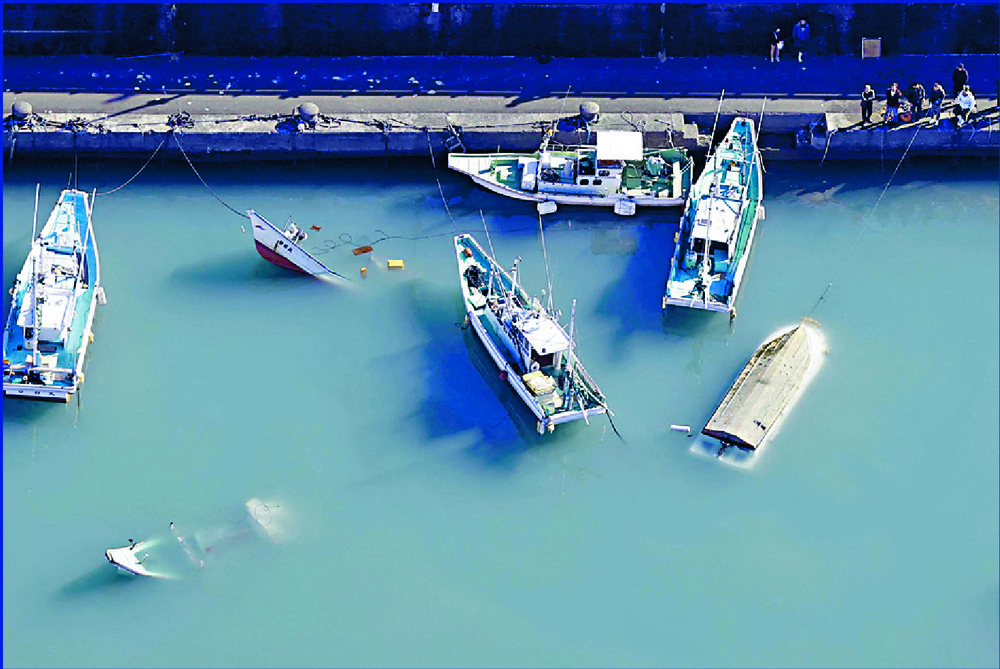 Submerged boats caused by huge waves in Japan and New Zealand. REUTERS, AP