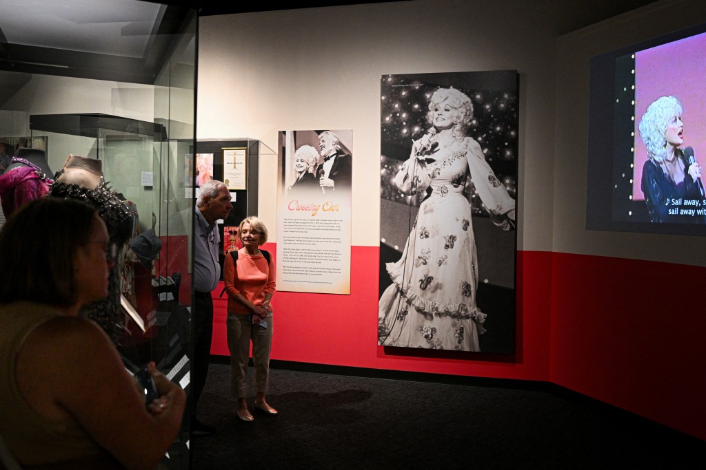 Photo by CHANDAN KHANNA / AFP People visit the Dolly Parton exhibit at the Country Music Hall of Fame in Nashville, Tennessee, on August 26, 2026.