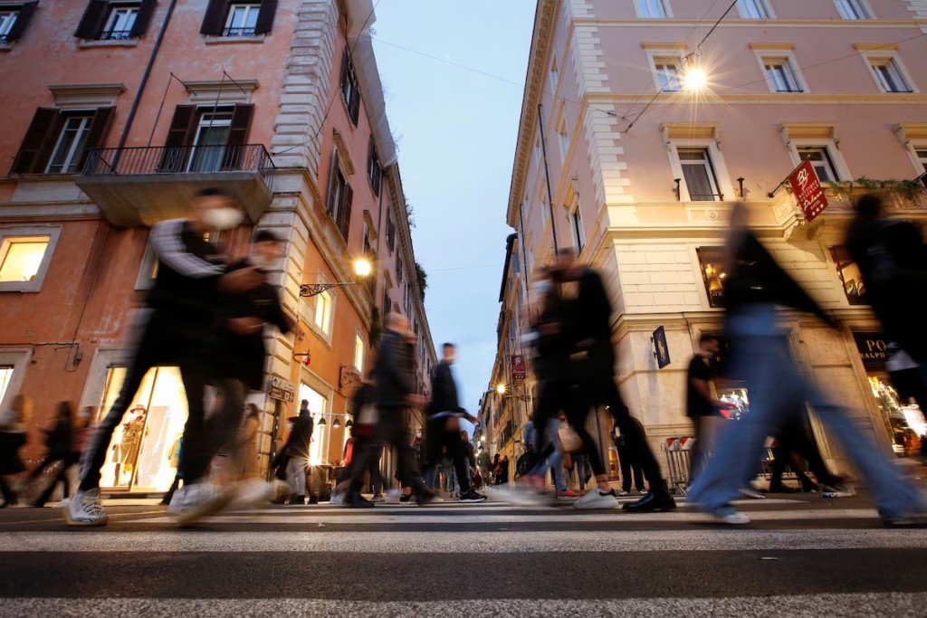 People walk along the principal shopping street of Via del Corso, in Rome, Italy, November 14, 2020. REUTERS