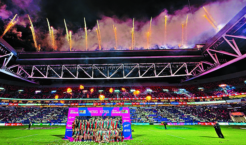 Fireworks light up the night sky as players celebrate, along with top officials John Lee, Rosanna Law and Paul Chan. Far left: a Cathay jet flies over Kai Tak to mark the city's 100 years of aviation history.SING TAO