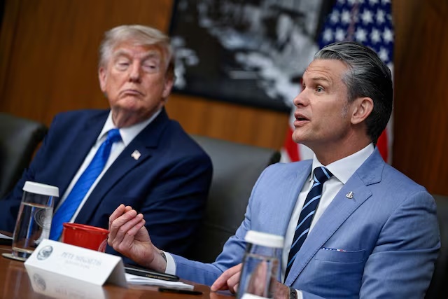 U.S. President Donald Trump listens as Secretary of Defense Pete Hegseth speaks during a cabinet meeting at Camp David in Thurmont, Maryland, U.S., July 31, 2026. REUTERS/Daniel Heuer/File Photo