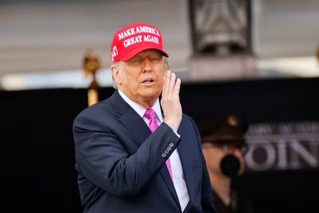 U.S. President Donald Trump wears a 'Make America Great Again' (MAGA) hat as he attends the commencement ceremony at West Point Military Academy in West Point, New York, U.S., May 24, 2025. REUTERS/Eduardo Munoz/File Photo