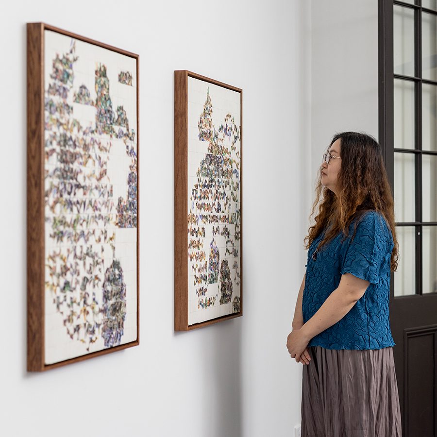 Sophie Cheung and her artworks 'Lion Rock from Above' and 'Mount Fuji from Above'. Cathay Pacific