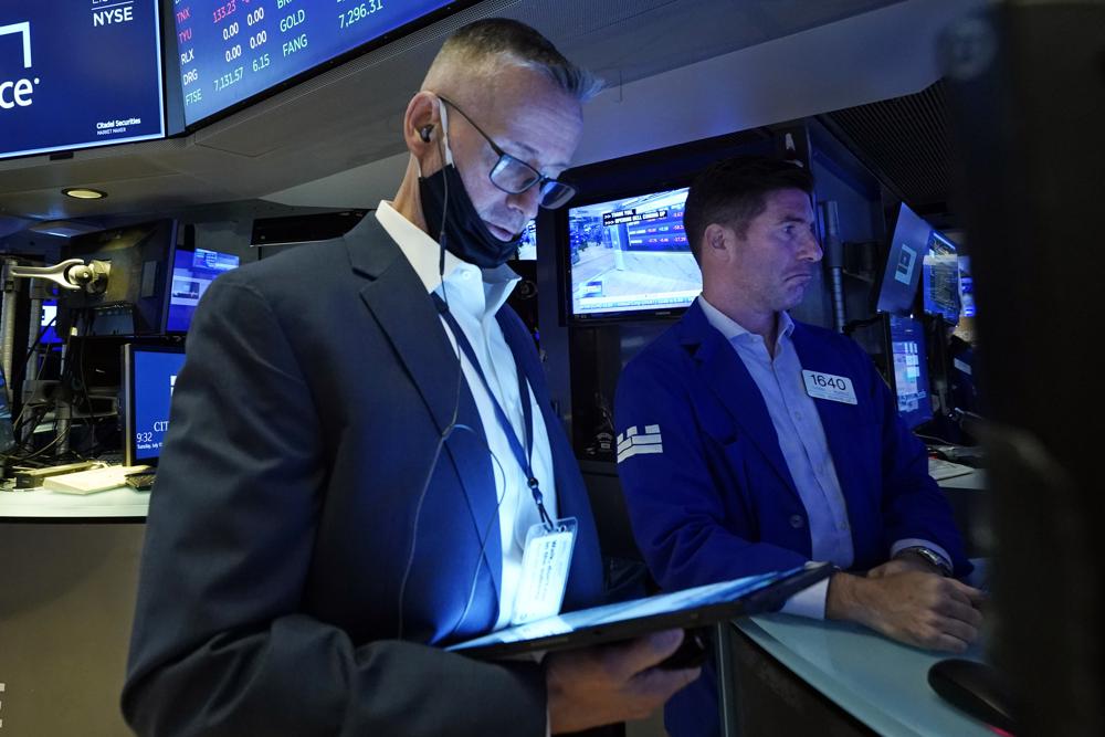 Trader Neil Catania, left, and specialist Thomas McArdle work on the floor of the New York Stock Exchange, Tuesday, July 13, 2021. Trader Neil Catania, left, and specialist Thomas McArdle work on the floor of the New York Stock Exchange, Tuesday, July 13, 2021.