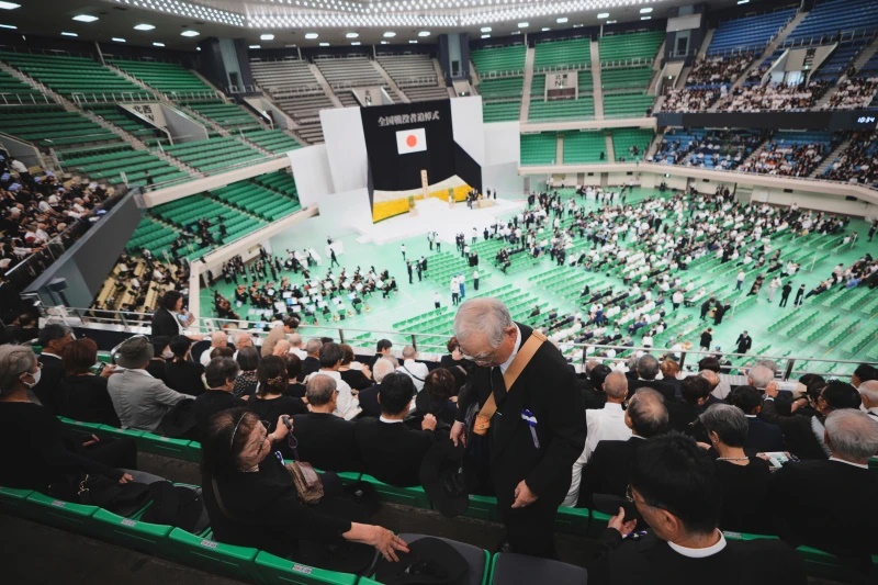 Guests prepare to attend a memorial service marking the 80th anniversary of Japan’s World War II defeat, at the Nippon Budokan hall in Tokyo. (AP Photo/Eugene Hoshiko)