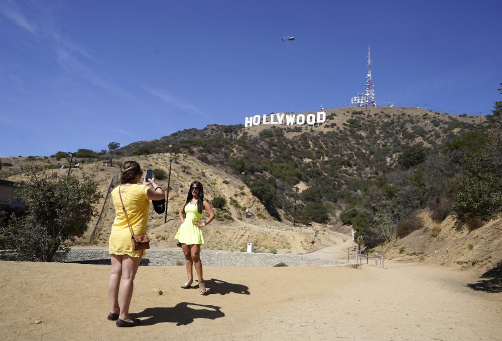 Nika Najafova, left, takes a picture of her friend Aysaba Mirzayeva below the Hollywood sign on Sept. 29, 2022, in Los Angeles. The Hollywood sign is getting a makeover befitting its status as a Tinseltown icon. (AP) Nika Najafova, left, takes a picture of her friend Aysaba Mirzayeva below the Hollywood sign on Sept. 29, 2022, in Los Angeles. The Hollywood sign is getting a makeover befitting its status as a Tinseltown icon. (AP)