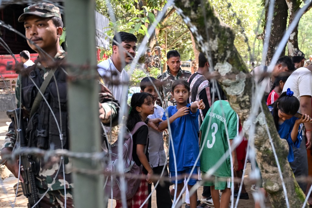 Photo by ARUN SANKAR / AFP  Children identify their parents after being rescued from a flash flood site at Trishuli Army camp in Nepal's Nuwakot district on August 28, 2026.
