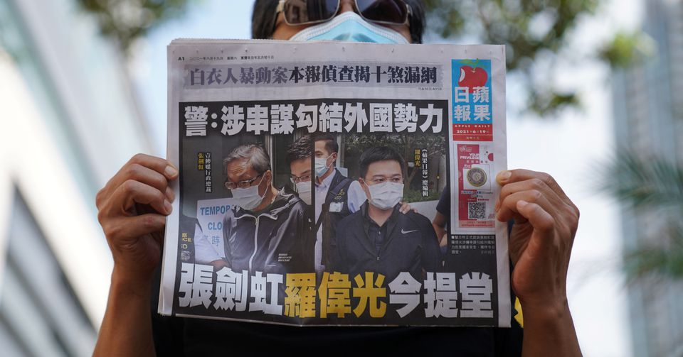 A supporter holds a copy of Apple Daily newspaper during a court hearing outside West Magistrates’ Courts, after police charge two executives of the pro-democracy Apple Daily newspaper over the national security law. A supporter holds a copy of Apple Daily newspaper during a court hearing outside West Magistrates’ Courts, after police charge two executives of the pro-democracy Apple Daily newspaper over the national security law.