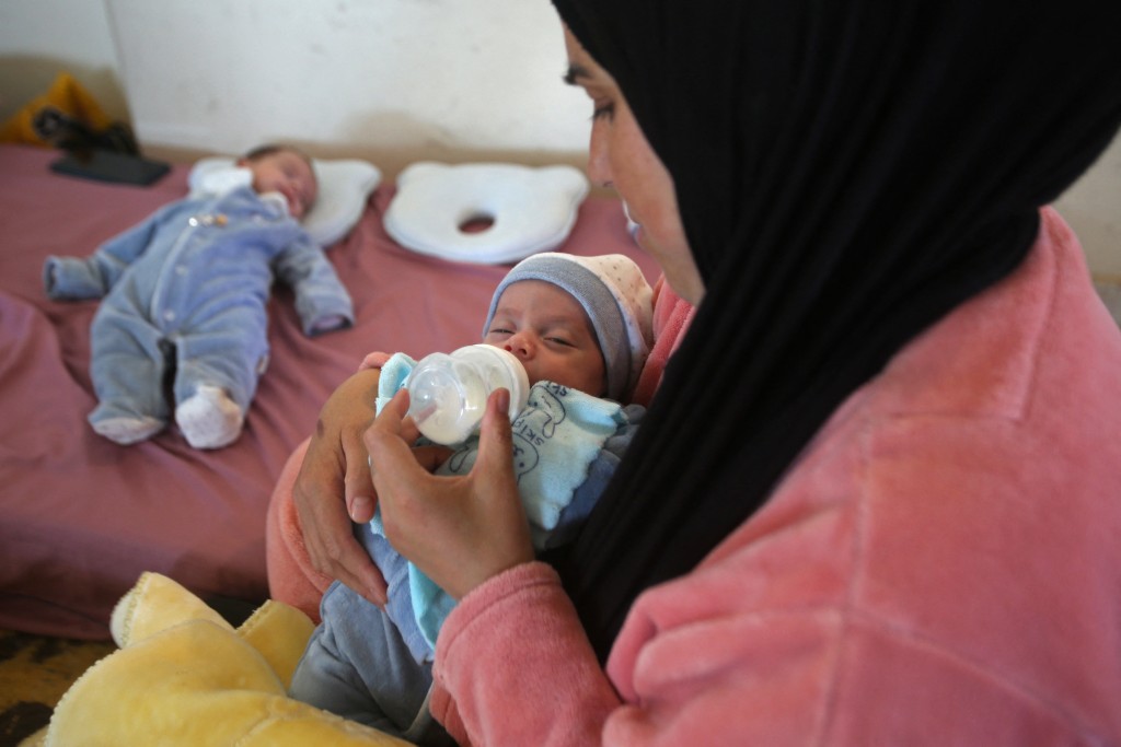 Photo by MAHMOUD ZAYYAT / AFP  Lebanese displaced woman Ghada Fadel feeds one of her twin sons at a shelter for displaced people in the southern Lebanese coastal city of Sidon on April 13, 2026.