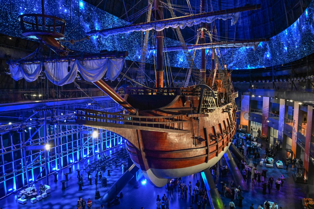 Photo by JAM STA ROSA / AFP  This photo taken on April 23, 2026 shows visitors under the Galeon Espiritu Santo, a full-scale representation of a 17th century galleon, on display at the Museo del Galeon in Manila.