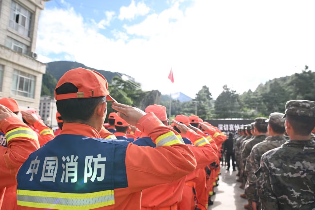 Rescue workers salute during a memorial service to mourn the victims of the August 26 mudslide, in Gyirong county, Shigatse, Tibet Autonomous Region, China September 1, 2026. cnsphoto via REUTERS