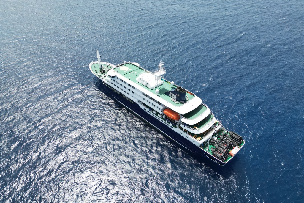 Photo by - / AFP  This aerial picture shows a general view of the cruise ship MV Hondius stationary off the port of Praia, the capital of Cape Verde, on May 4, 2026.