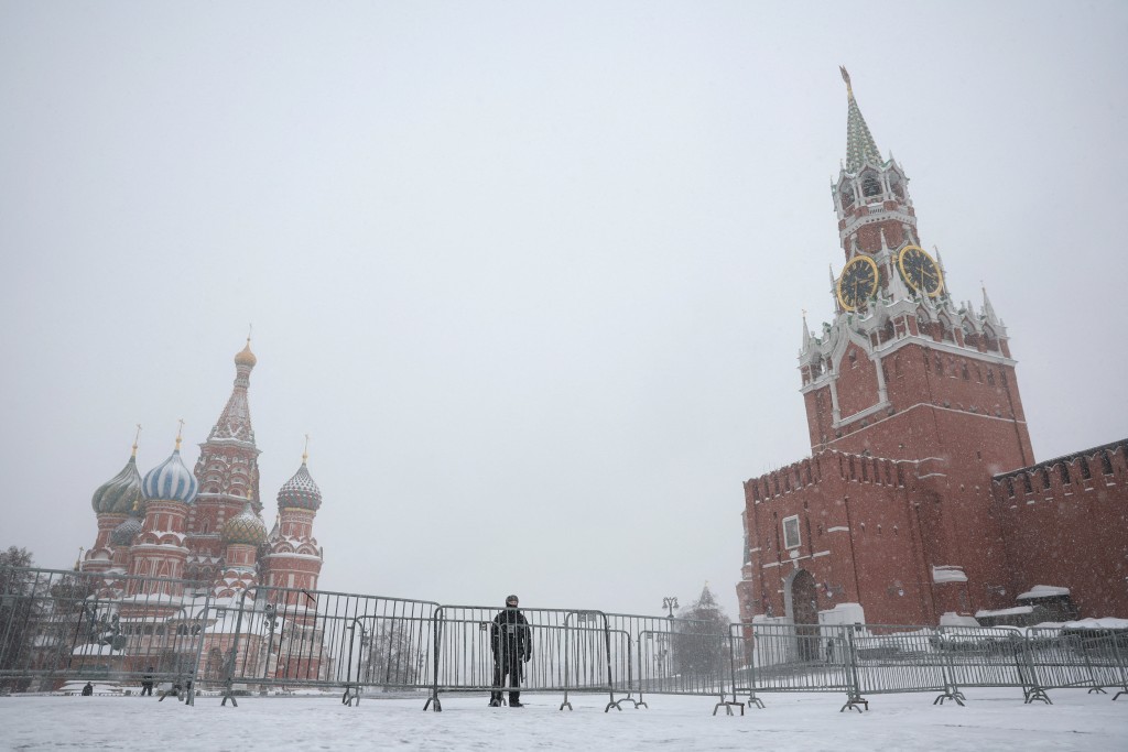 A law enforcement officer stands guard in Red Square near St. Basil's Cathedral and the Kremlin's Spasskaya Tower on a snowy day in central Moscow, Russia, February 24, 2026. (Reuters)