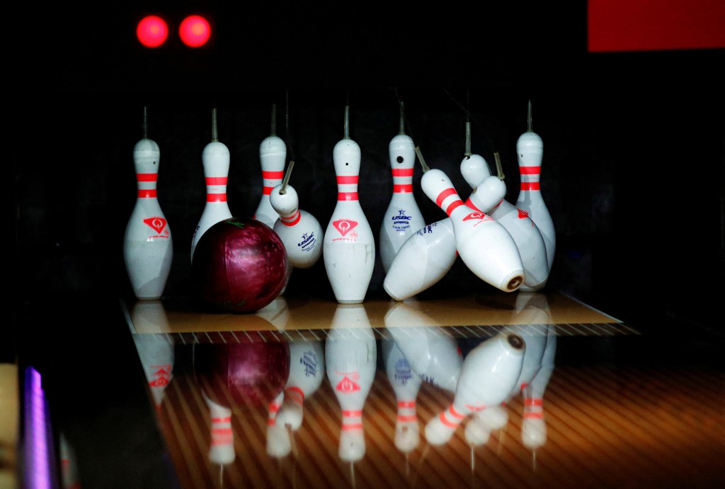 FILE PHOTO: A bowling ball hits the pins at Hollywood Bowl in Lakeside in Grays, Britain, August 18, 2020.  REUTERS/Peter Cziborra/File Photo