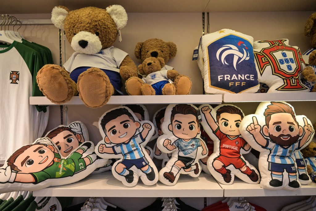 Photo by HECTOR RETAMAL / AFP  This photo taken on June 5, 2026 shows merchandise of football teams that will participate in the FIFA World Cup 2026 in a shop in Yiwu in eastern China's Zhejiang province.