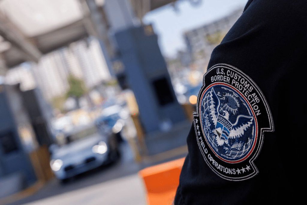 A U.S. Customs and Border Protection officer works at the border crossing between Mexico and into the United States at the San Ysidro border in San Diego, California, U.S., May 29, 2024. REUTERS/Mike Blake/File Photo 
