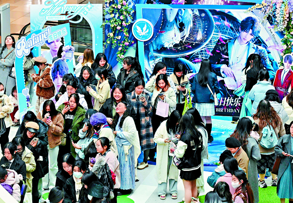 Young women attend a birthday celebration for Rafayel, a virtual character in the mobile game Love and Deepspace, at a shopping mall in Beijing, where they receive some merchandise. AFP