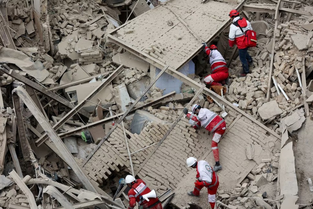 Emergency personnel work at the site of a strike on a residential building in Tehran, March 16. Majid Asgaripour/WANA