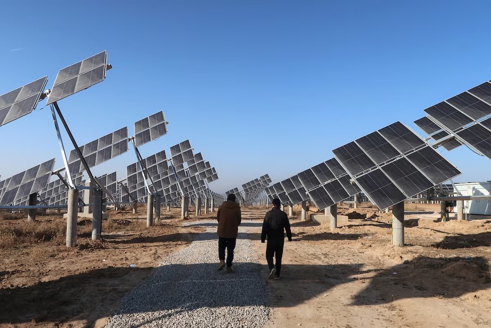 Workers walk at a solar power station in Tongchuan, Shaanxi province, China December 11, 2019. Picture taken December 11, 2019. REUTERS Workers walk at a solar power station in Tongchuan, Shaanxi province, China December 11, 2019. Picture taken December 11, 2019. REUTERS