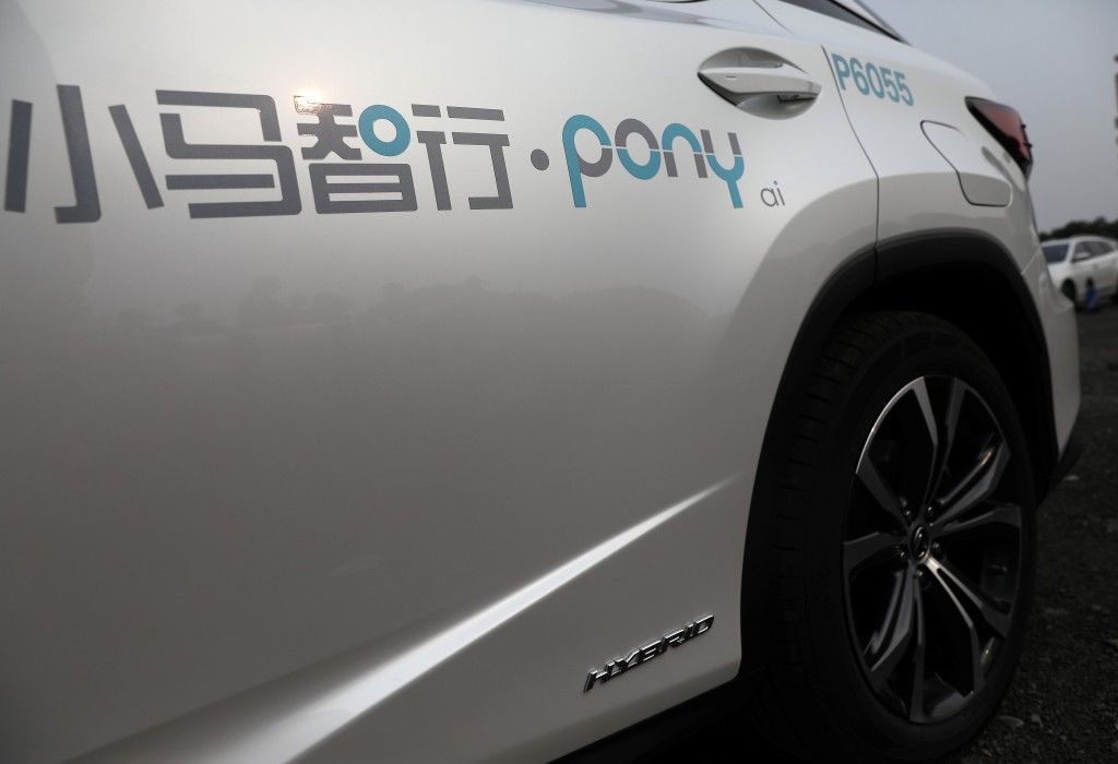 A logo of Pony.ai is seen on a Lexus vehicle equipped with the company's autonomous driving system, 2021. REUTERS/Tingshu Wang