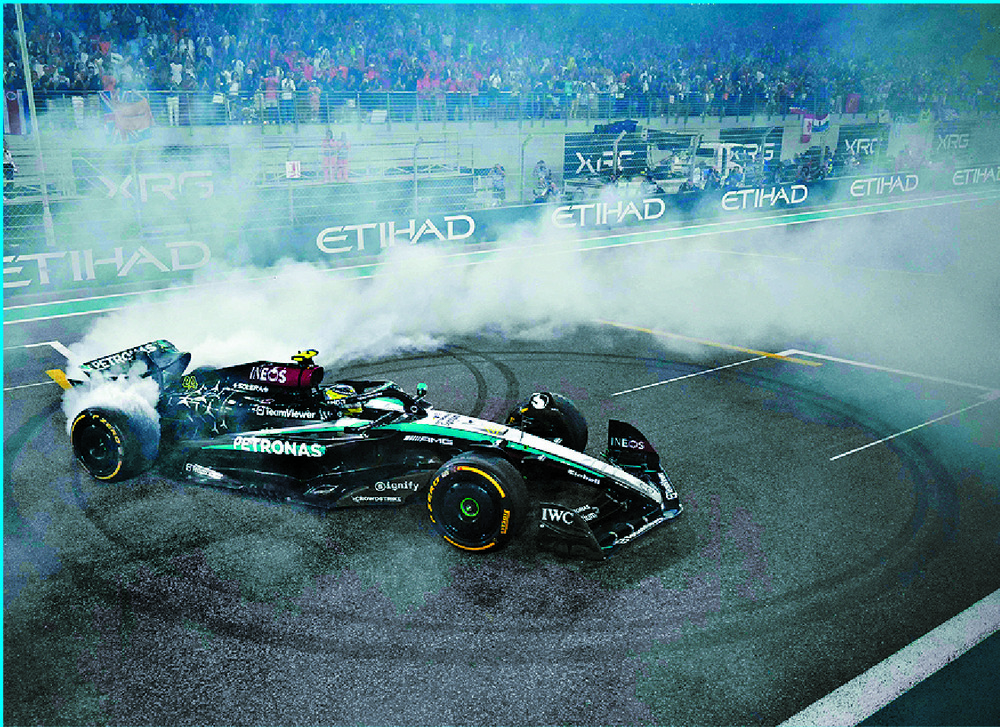 Lewis Hamilton spins his Mercedes into celebratory 'donuts.' AFP Lewis Hamilton spins his Mercedes into celebratory 'donuts.' AFP