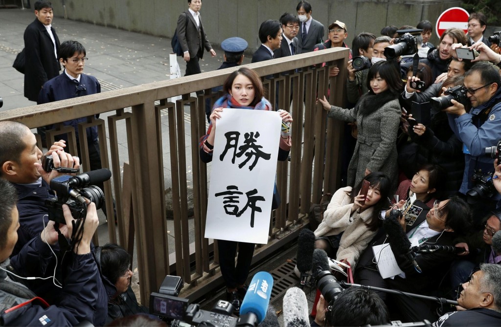 Japanese journalist Shiori Ito holds a banner reading "Victory" outside the Tokyo District Court after a court verdict ordered in Tokyo, Japan, in this photo taken by Kyodo December 18, 2019. Mandatory credit Kyodo/via REUTERS