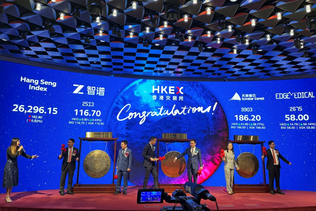Executives from artificial intelligence company Zhipu AI, also known as Knowledge Atlas Technology, semiconductor company Shanghai Iluvatar CoreX and surgical robotics company Shenzhen Edge Medical attend a listing ceremony at the Hong Kong Stock Exchange, in Hong Kong, China January 8, 2026. REUTERS