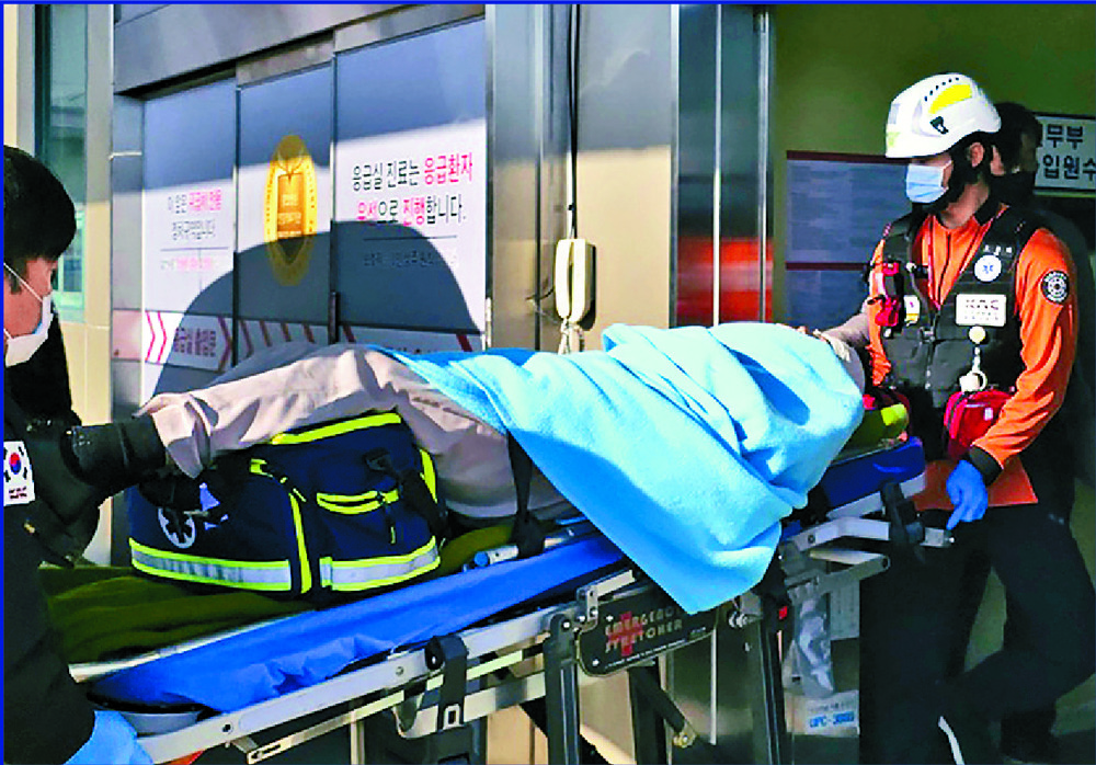 A survivor is taken to hospital, Jeju Air officials bow to apologize and loved ones of victims pour out their grief. AP, REUTERS