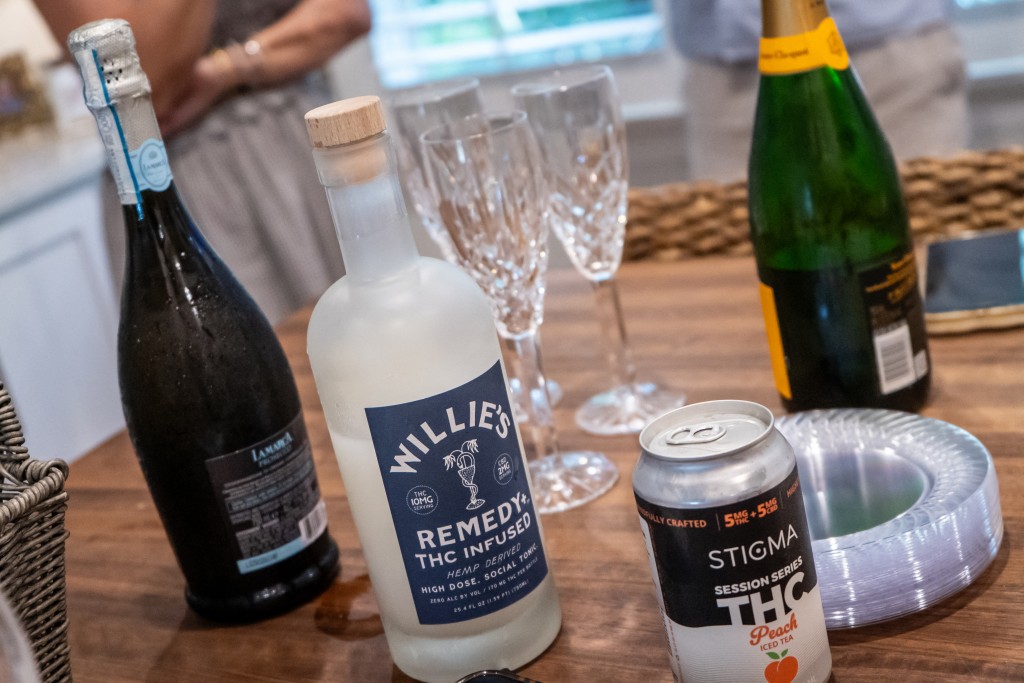 Photo by PAUL BLAKE / AFP A bottle of Willie's THC-infused drink is seen next to bottles of prosecco and champagne on a kitchen counter in Morehead City, North Carolina, on June 14, 2026.