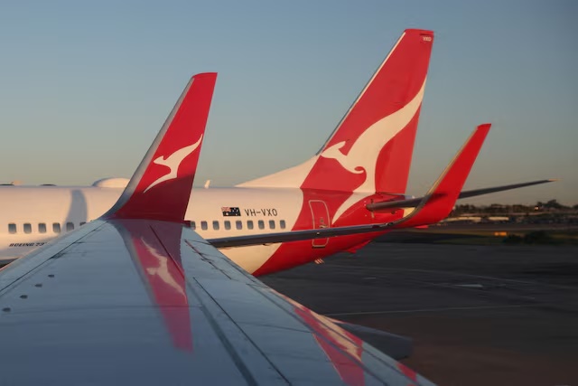 A Qantas logo is visible on the tail of an aeroplane at an airport in Sydney, Australia, September 18, 2025. REUTERS/Hollie Adams/File Photo