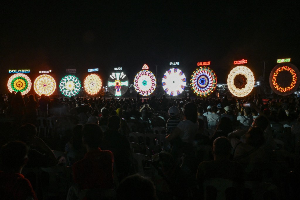 Photo by JAM STA ROSA / AFP  This photo taken on December 14, 2025, shows people watching during the Giant Lantern Festival in San Fernando, Pampanga.
