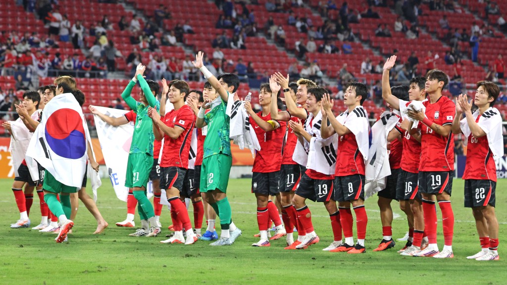 Photo by - / YONHAP / AFP  This picture taken on October 3, 2026 shows South Korean players celebrating after winning the gold medal in the men's football final match between Japan and South Korea in the 2026 Asian Games at Toyota Stadium in Toyota.