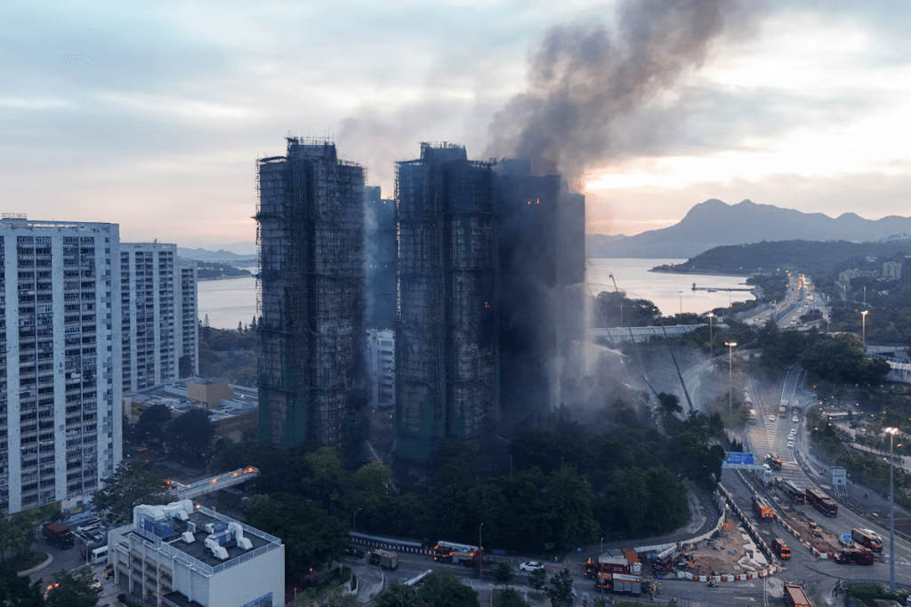 A drone view shows flames and thick smoke rising from the Wang Fuk Court housing estate during a major fire, in Tai Po, Hong Kong, China, November 27, 2025. REUTERS/Tyrone Siu