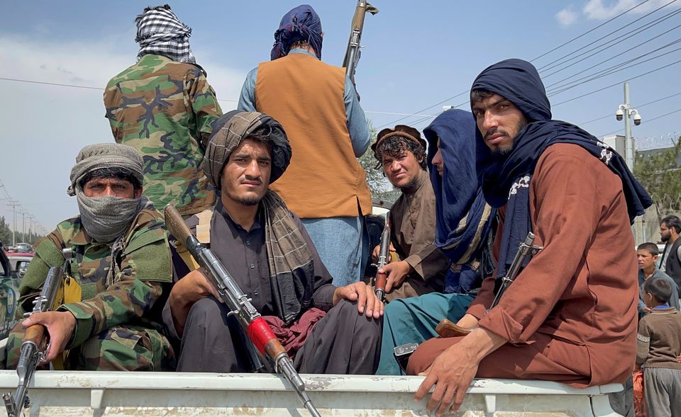 Taliban forces patrol near the entrance gate of Hamid Karzai International Airport, a day after U.S troops withdrawal. Taliban forces patrol near the entrance gate of Hamid Karzai International Airport, a day after U.S troops withdrawal.