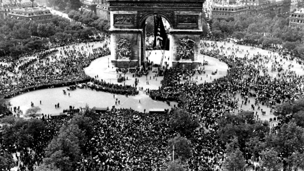 FILE - Thousands celebrate the announcement of Germany's unconditional surrender to the Allies in World War II, on May 7, 1945, at the Arc de Triomphe in Paris on VE Day. (AP Photo/File)