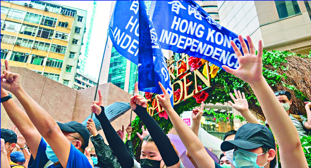 Protesters in Causeway Bay carry 'Hong Kong independence' banners and colonial flags. Protesters in Causeway Bay carry 'Hong Kong independence' banners and colonial flags.