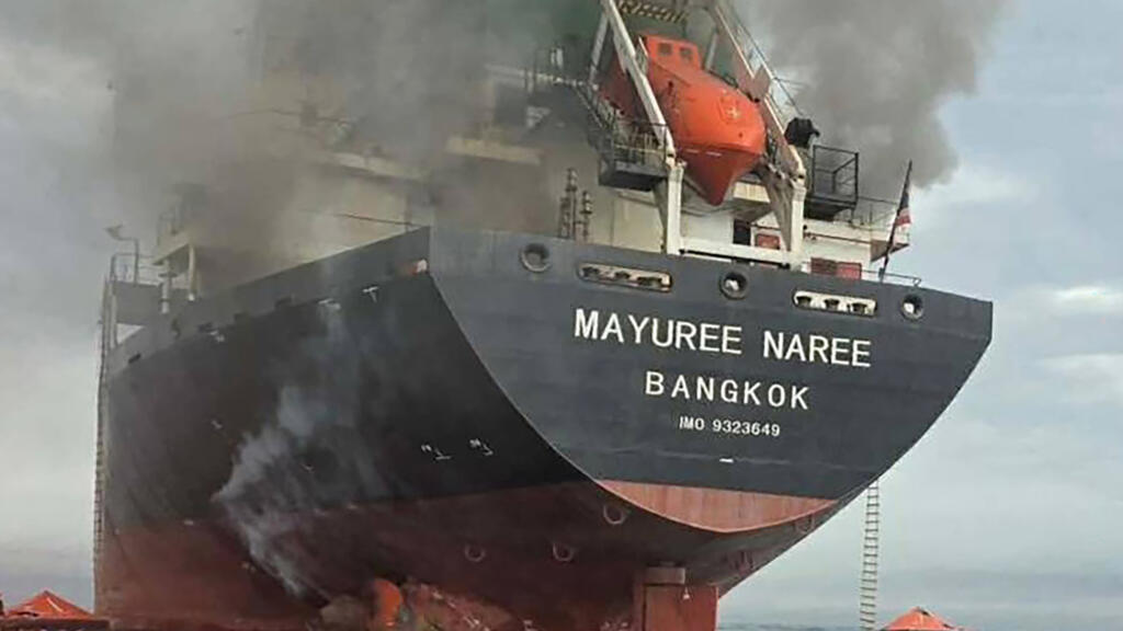 Three crew members were "believed to be trapped" aboard a Thai bulk carrier that was hit by two projectiles while travelling through the crucial Strait of Hormuz, the vessel's owner said © Handout / ROYAL THAI NAVY/AFP