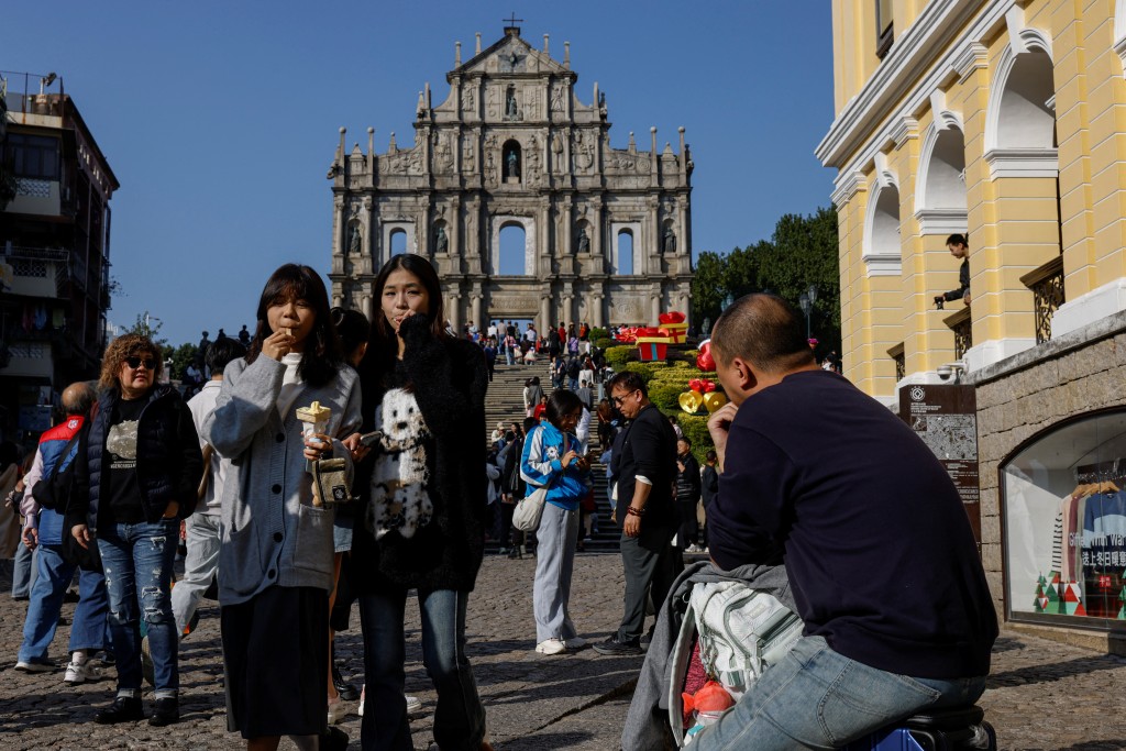 Visitors walk in front of the Ruins of Saint Paul's, in Macau, China December 17, 2024. REUTERS