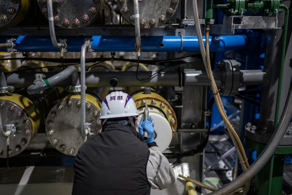 Photo by PHILIP FONG / AFP  This picture taken on January 14, 2026 shows a staff member changing a part of the osmosis membrane facilities at Sea Water Desalination Plant in Fukuoka.
