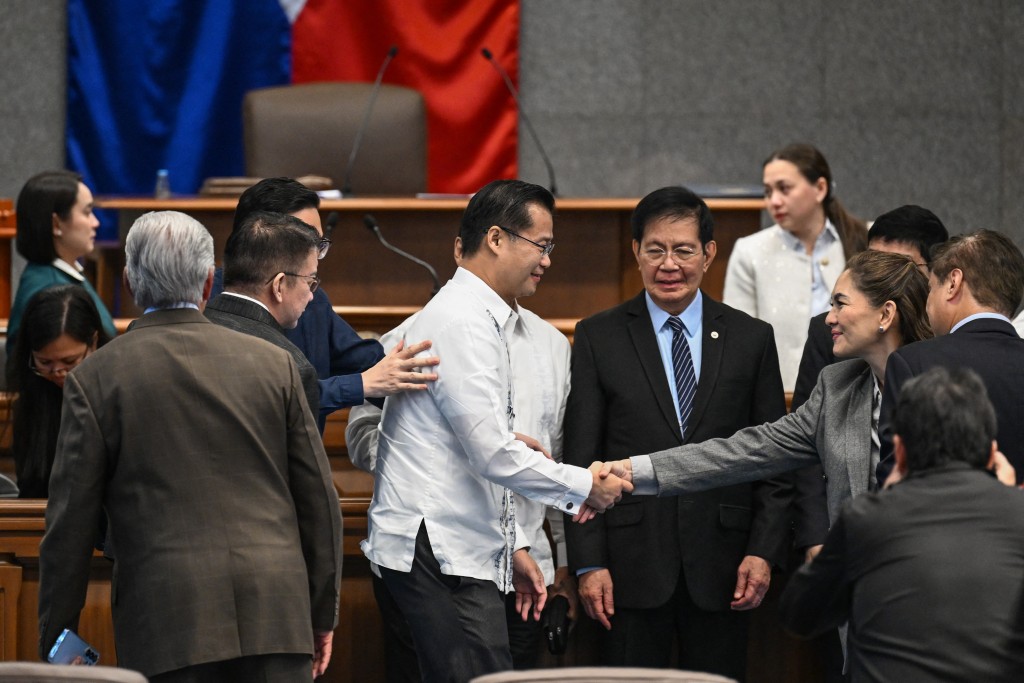 Photo by JAM STA ROSA / AFP  Philippine Senator Sherwin Gatchalian (C) shakes hands with the senators after the plenary session at the Senate of the Philippines in Pasay, Metro Manila on June 3, 2026.