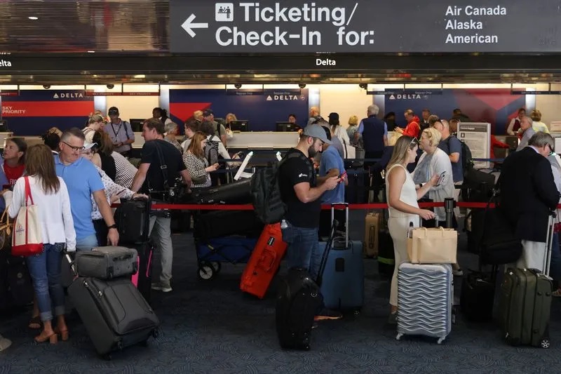 Passengers wait at Milwaukee Mitchell International Airport in Milwaukee, Wisconsin, U.S., July 19, 2024. REUTERS/Jennah Moon