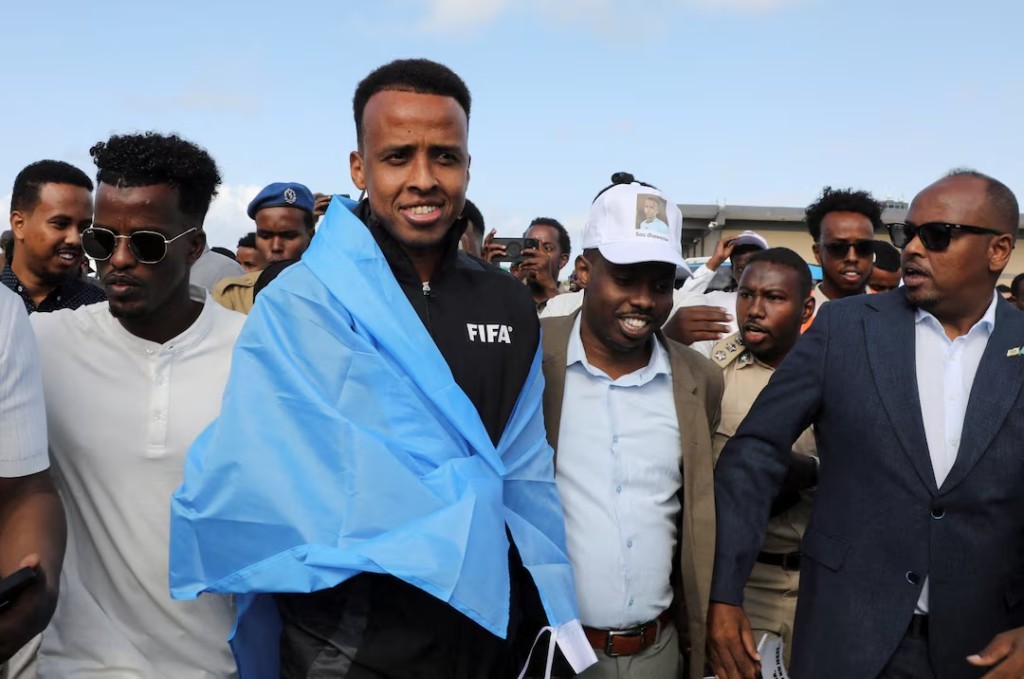  Somali referee Omar Abdulkadir Artan, who had been expected to officiate at matches during the 2026 FIFA World Cup but was denied entry to the United States, is received as he arrives at the Aden Abdulle Osman International Airport in Mogadishu, Somalia June 10, 2026. REUTERS/Feisal Omar