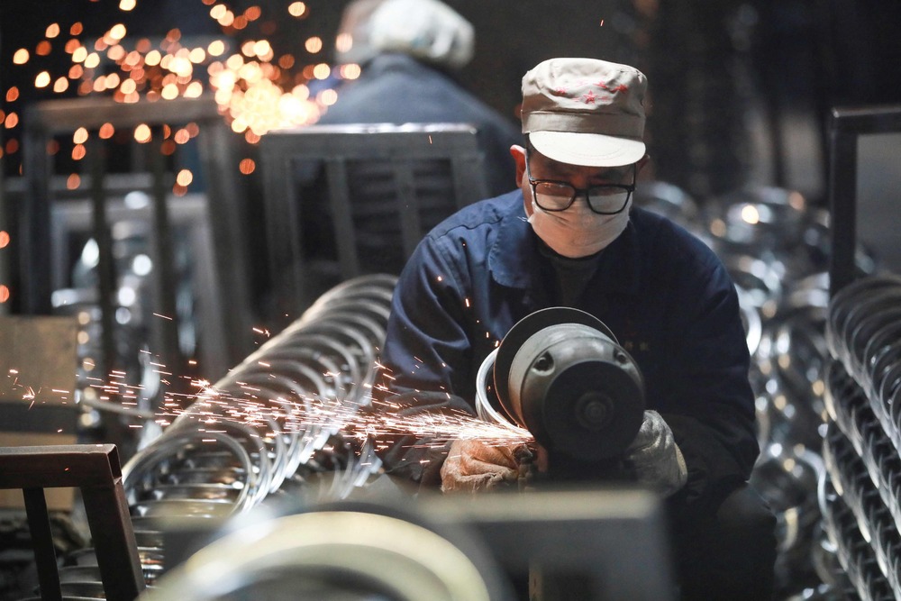 A worker processes stainless steel rings for bicycle for export at a factory in Hangzhou, in eastern China's Zhejiang province on February 20, 2025. AFP A worker processes stainless steel rings for bicycle for export at a factory in Hangzhou, in eastern China's Zhejiang province on February 20, 2025. AFP