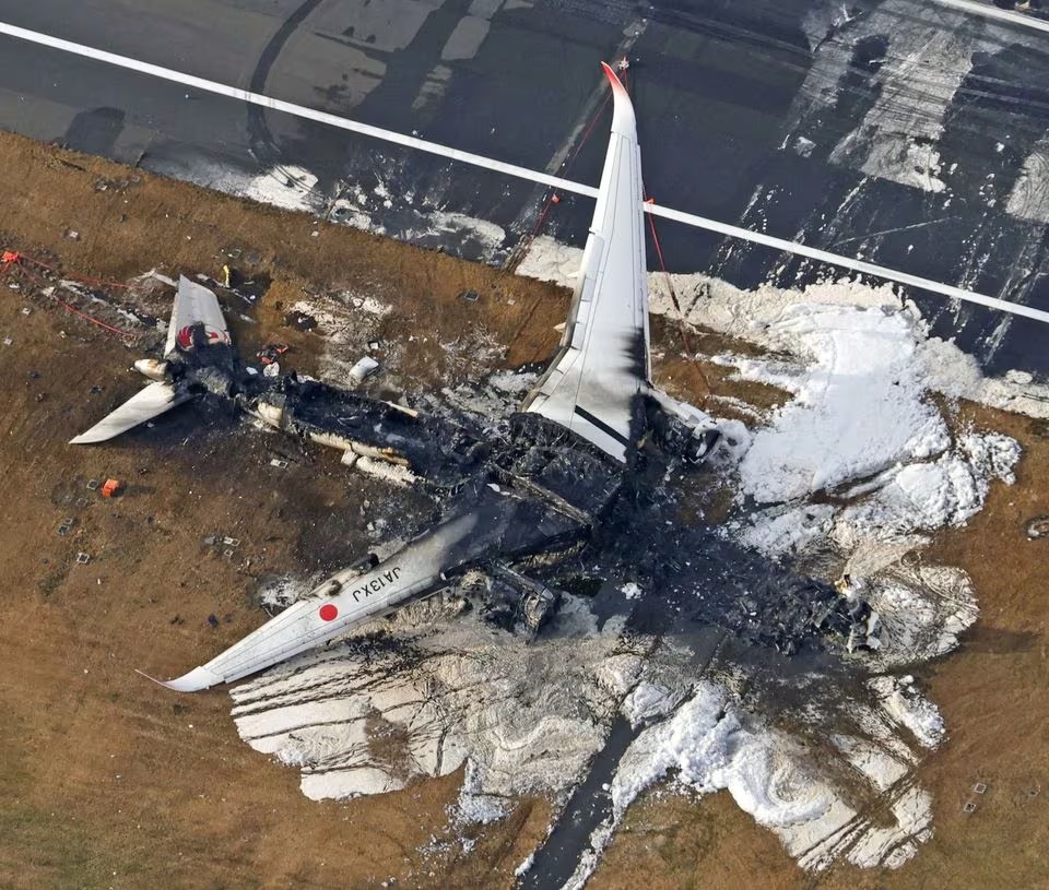 An aerial view shows burnt Japan Airlines' (JAL) Airbus A350 plane after a collision with a Japan Coast Guard aircraft at Haneda International Airport in Tokyo, Japan January 3, 2024, in this photo taken by Kyodo. Mandatory credit Kyodo/via REUTERS An aerial view shows burnt Japan Airlines' (JAL) Airbus A350 plane after a collision with a Japan Coast Guard aircraft at Haneda International Airport in Tokyo, Japan January 3, 2024, in this photo taken by Kyodo. Mandatory credit Kyodo/via REUTERS