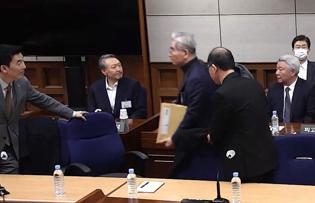 Photo by HANDOUT / YONHAP / AFP  This screen grab made from a handout video distributed by the Seoul Central District Court and released by Yonhap shows South Korea's former president Yoon Suk Yeol (2nd row, L) attending a sentencing trial on his insurrection charges at the Seoul Central District Court in Seoul on February 19, 2026.