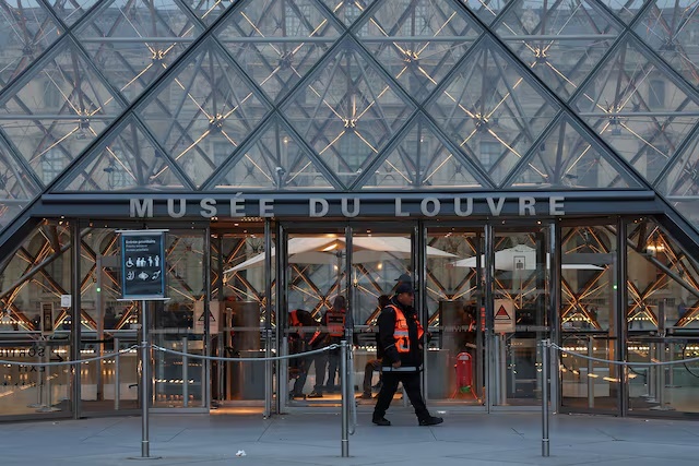 A security member walks at the Louvre Museum, after French police arrested suspects in the Louvre heist case, in Paris, France, October 26, 2025. REUTERS/Abdul Saboor
