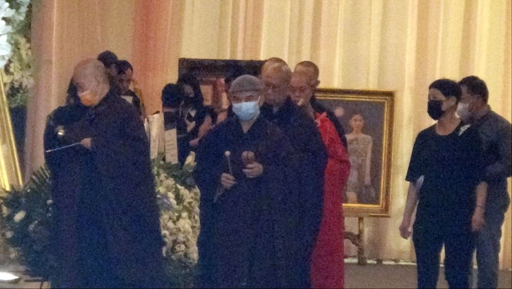 Buddhist monks lead the service at Ngong Ping for slain model Abby Choi. Buddhist monks lead the service at Ngong Ping for slain model Abby Choi.