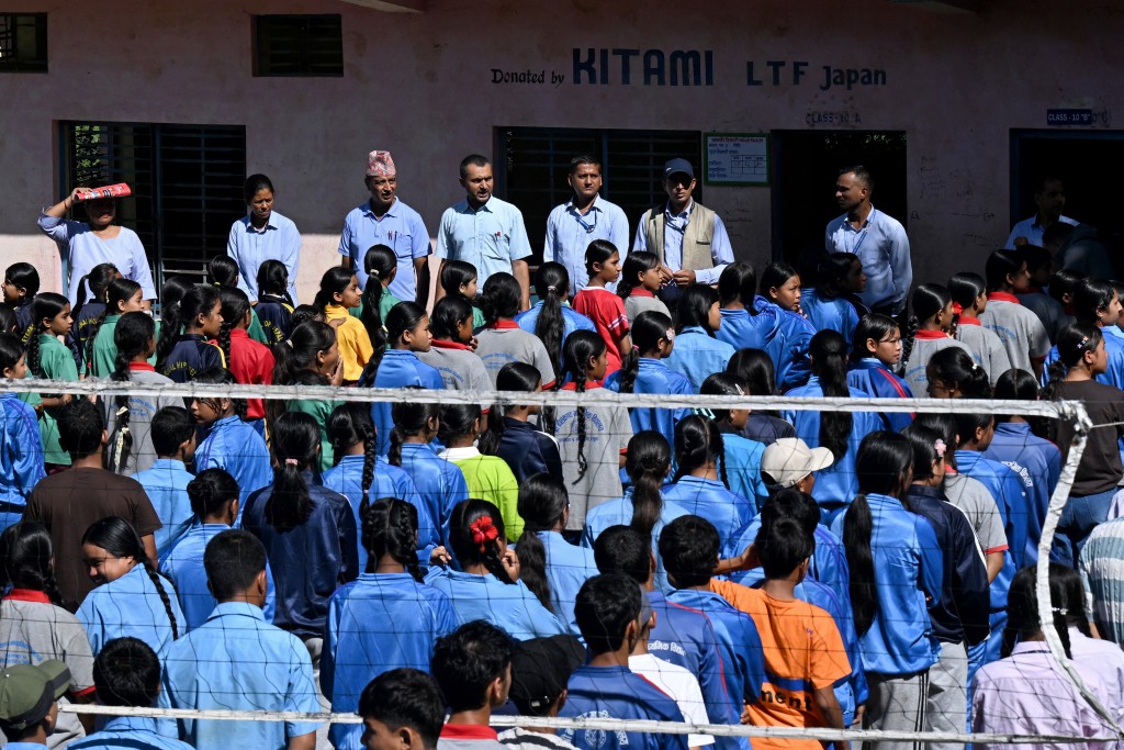 Photo by PRAKASH MATHEMA / AFP Students gather to take part in an assembly at Neelakantha Secondary School following the August 26 flash flood, at Betrawati in Nepal's Rasuwa district on September 28, 2026.