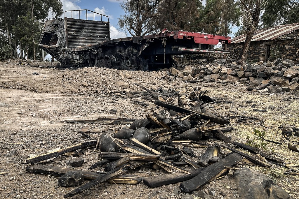 A truck belonging to the Tigray People's Liberation Front (TPLF) stands burned along a road next to mortar shells and other ammunition remnants following clashes between Ethiopian federal forces and armed groups opposed to the government in Adigrat on October 17, 2026.